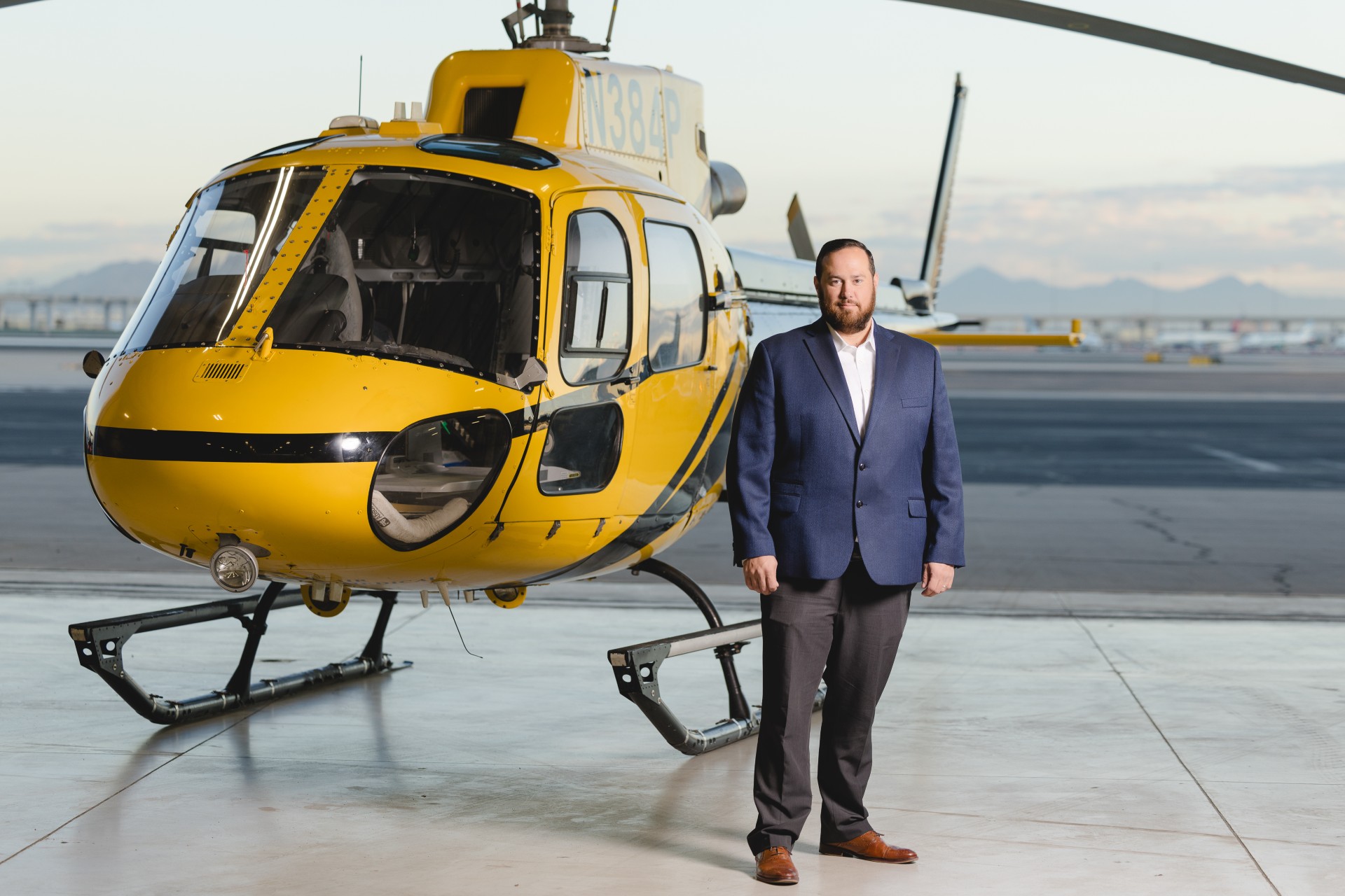 Christopher Hardman standing next to a helicopter