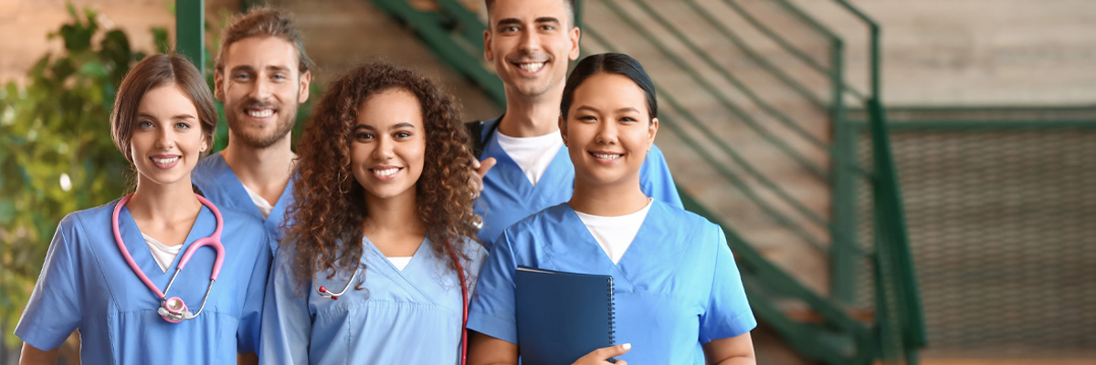 A diverse group of young nursing students standing together.