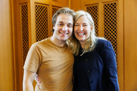 2023 Distinguished Alumni Award winner and former dean Ann Kurth ’90 MSN celebrates with her son.