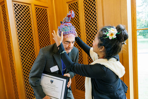 2021 honoree Wailua Brandman ’94 MSN receives a ceremonial headdress at the conclusion of the event.
