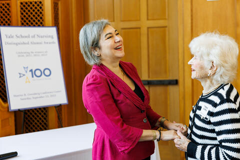 Dean Emami embraces Thelma Joseph ’46 M.N., who is celebrating her personal centennial this year.