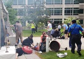 During the mass-casualty simulation, a runaway golf cart careened into a gas grill at a community cookout, prompting an explosion.