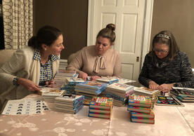 YSNAA members preparing board books for babies in the local NICU.